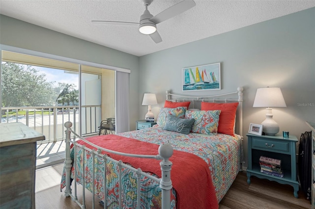 bedroom featuring a textured ceiling, dark hardwood / wood-style flooring, and ceiling fan