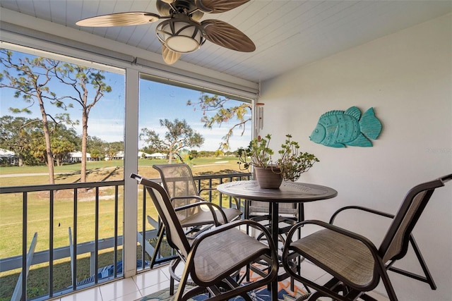 sunroom with ceiling fan and wooden ceiling