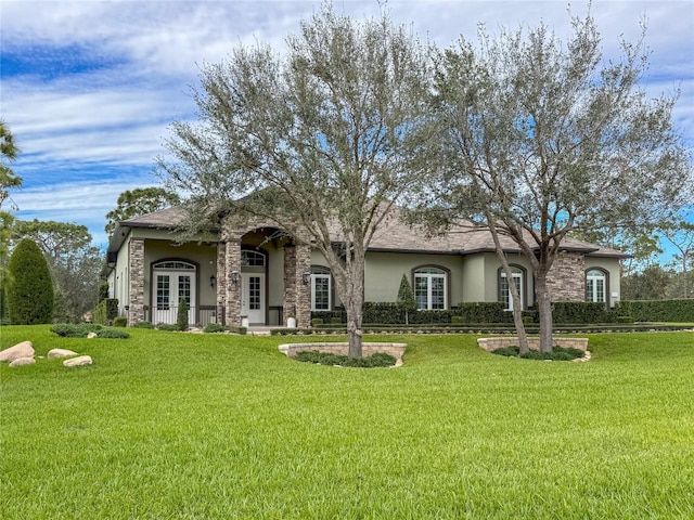 view of front of house featuring a front yard and french doors