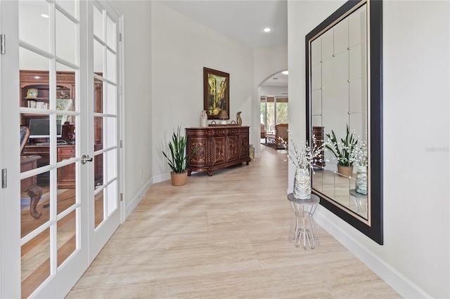 hall featuring french doors and light wood-type flooring