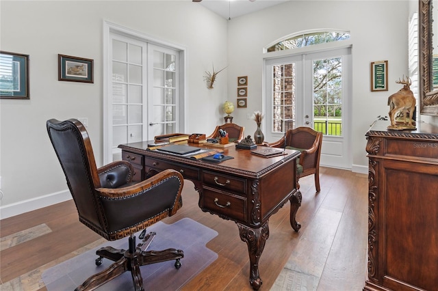 office featuring light hardwood / wood-style flooring and french doors