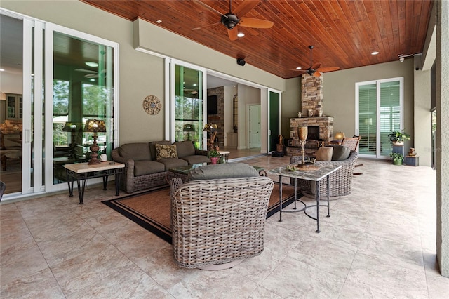 view of patio / terrace featuring an outdoor living space with a fireplace and ceiling fan