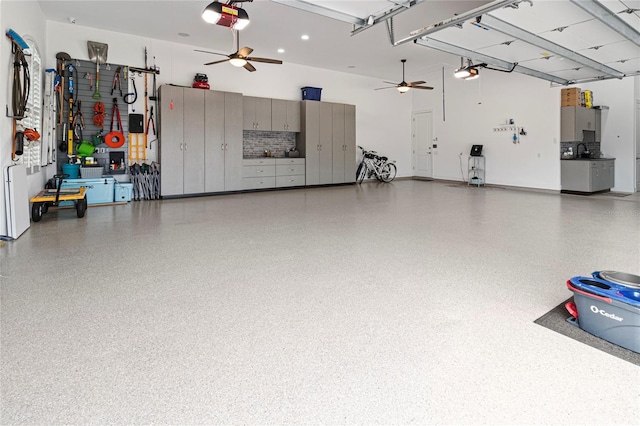 garage with ceiling fan and a garage door opener