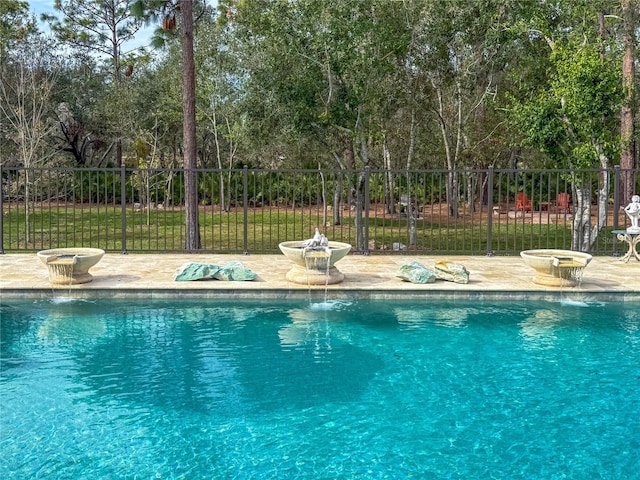 view of swimming pool with pool water feature