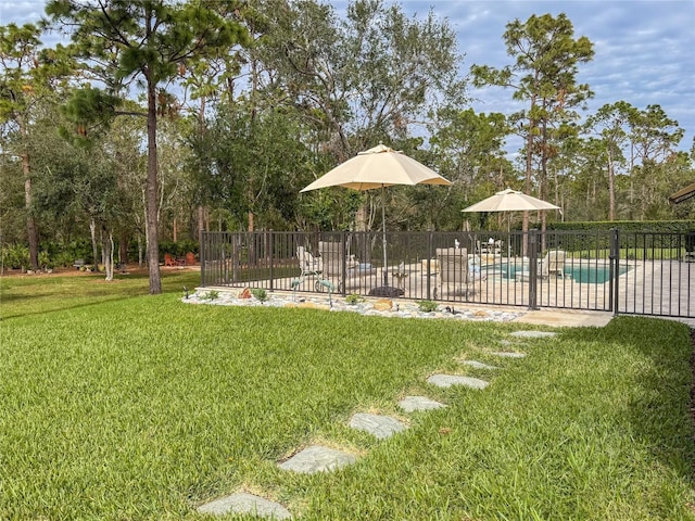 view of yard featuring a fenced in pool and a patio