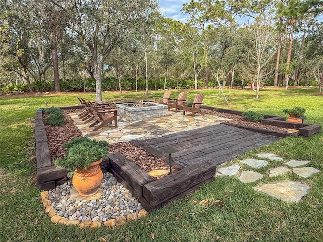 view of yard featuring a fire pit and a patio