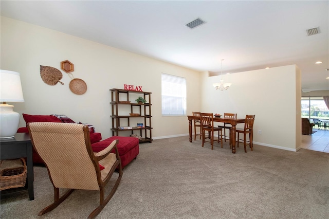 dining area with light carpet and an inviting chandelier