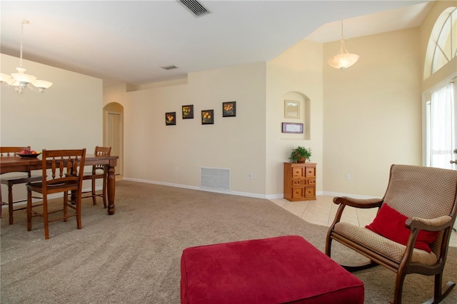 interior space featuring light carpet and a chandelier