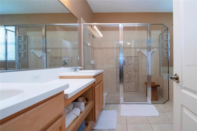 bathroom with tile patterned flooring, vanity, and a shower with door