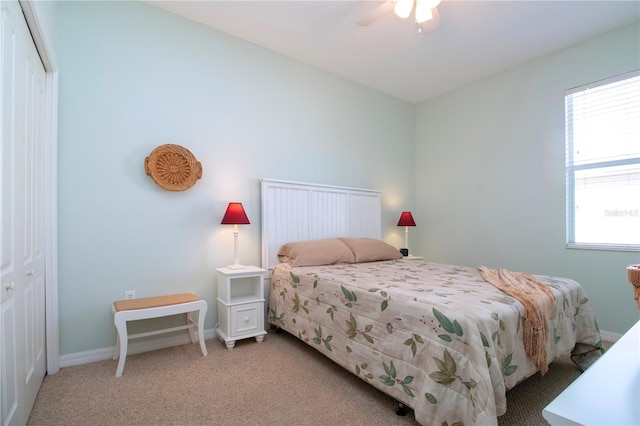 carpeted bedroom featuring ceiling fan and a closet