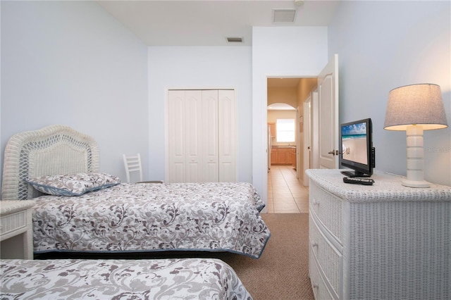 tiled bedroom featuring a closet