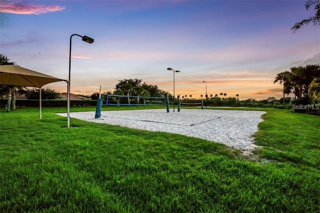 view of home's community with volleyball court and a yard