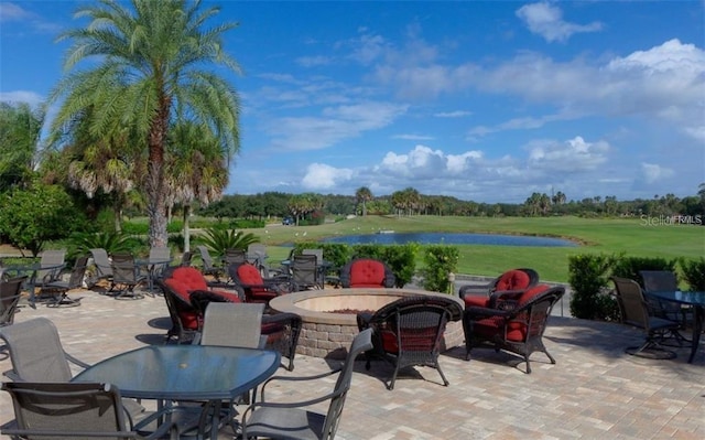 view of patio with a water view and an outdoor fire pit