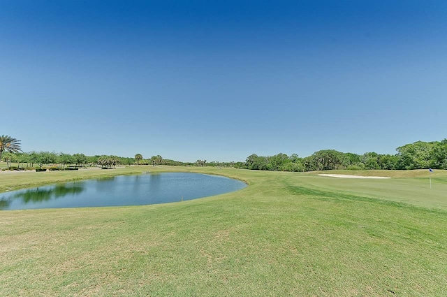 view of community with a water view and a lawn