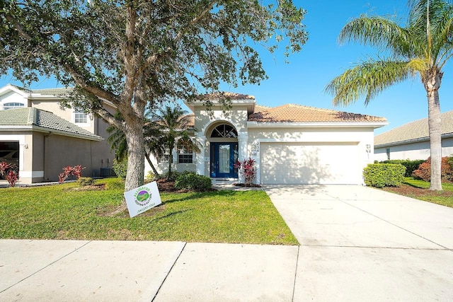 236 Golden Harbour Trl, Bradenton, FL 34212 - mediterranean / spanish-style home featuring a garage, driveway, a front yard, and stucco siding