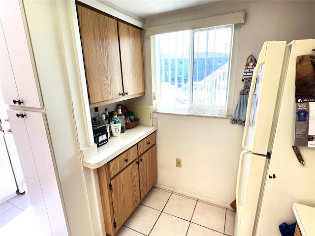 kitchen featuring white refrigerator and light tile patterned flooring