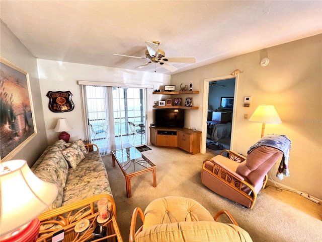 carpeted living room with ceiling fan