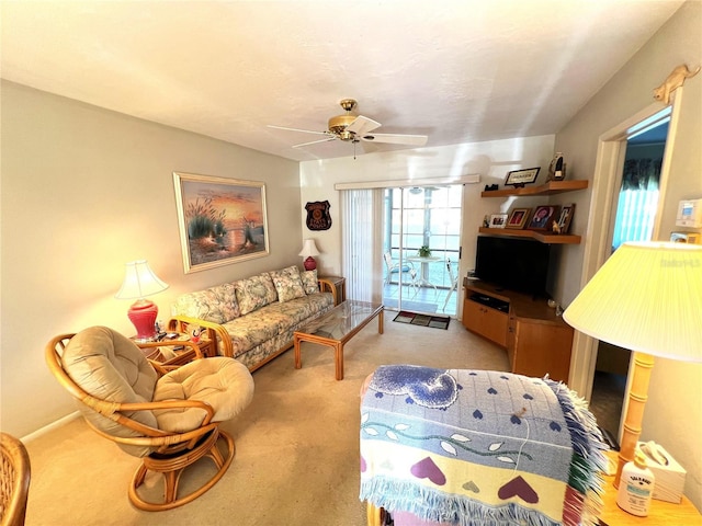 carpeted living room with ceiling fan