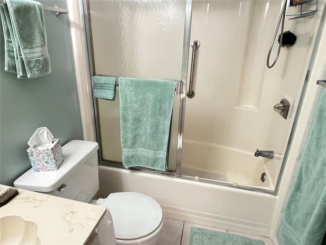 full bathroom featuring combined bath / shower with glass door, vanity, toilet, and tile patterned flooring