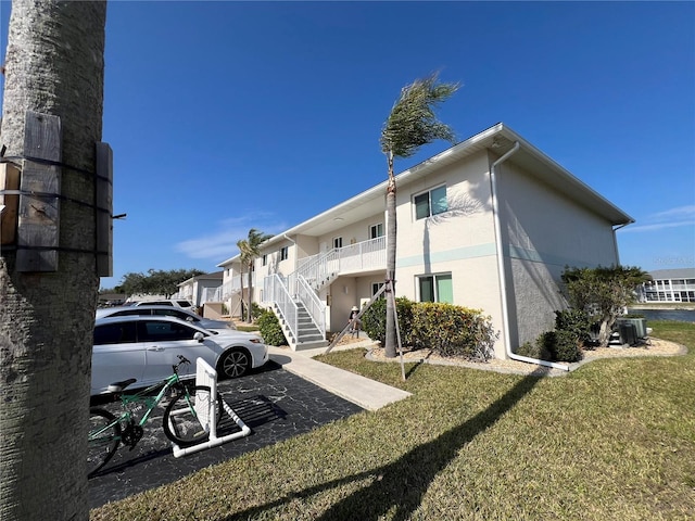 exterior space with a yard and central AC unit