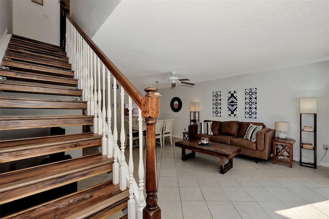 tiled living room with ceiling fan and a textured ceiling