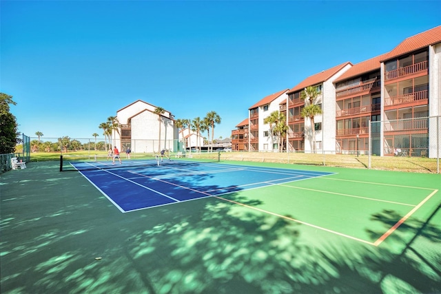 view of tennis court featuring basketball hoop