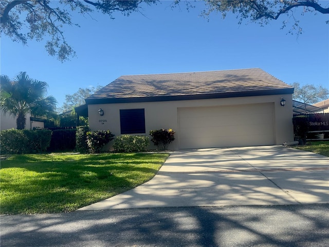 view of front of property featuring a garage and a front yard