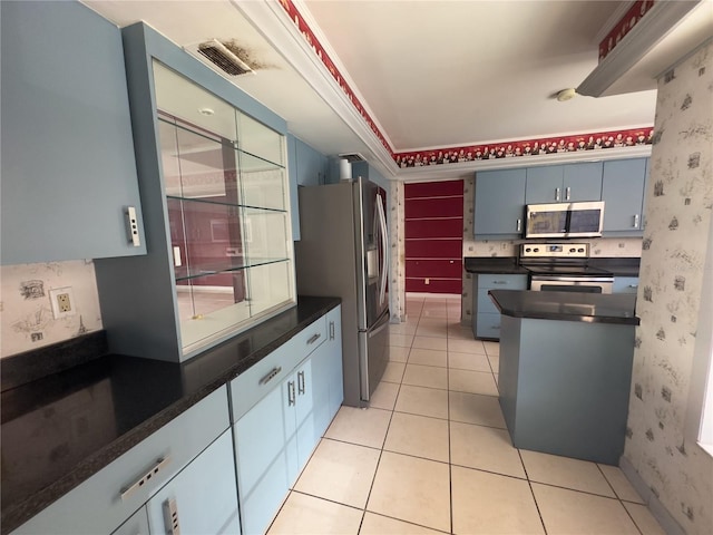 kitchen with stainless steel appliances, crown molding, and light tile patterned floors