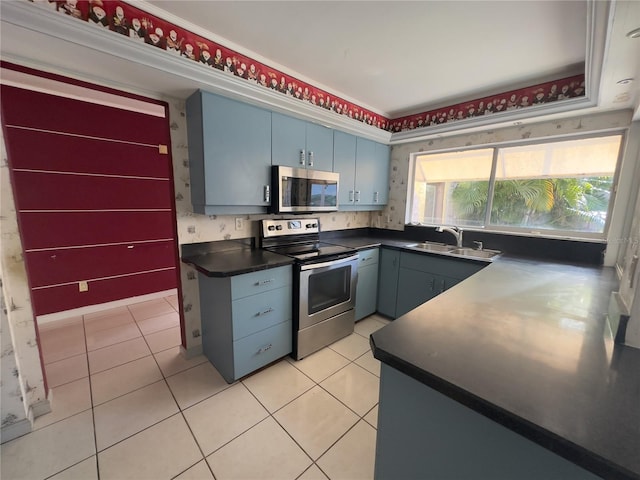 kitchen with light tile patterned flooring, stainless steel appliances, crown molding, and sink