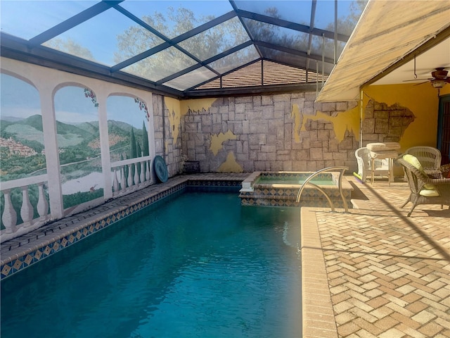 view of swimming pool with a patio, a lanai, ceiling fan, and a mountain view