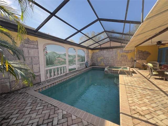 view of pool with an in ground hot tub, a lanai, ceiling fan, and a patio area