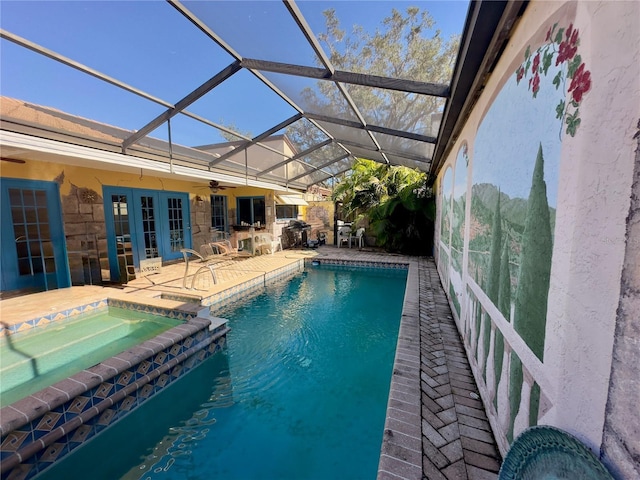 view of swimming pool featuring an in ground hot tub, a lanai, and a patio area