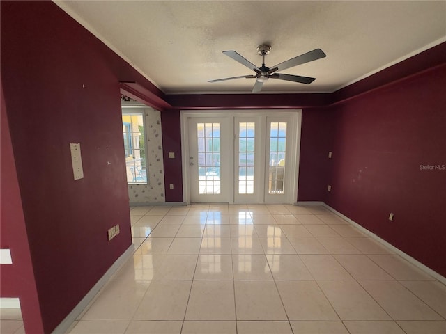 tiled empty room with ceiling fan and a textured ceiling