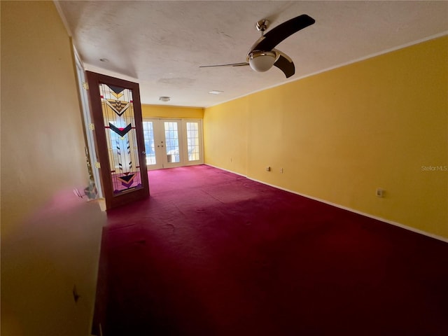 spare room with carpet floors, french doors, and ceiling fan