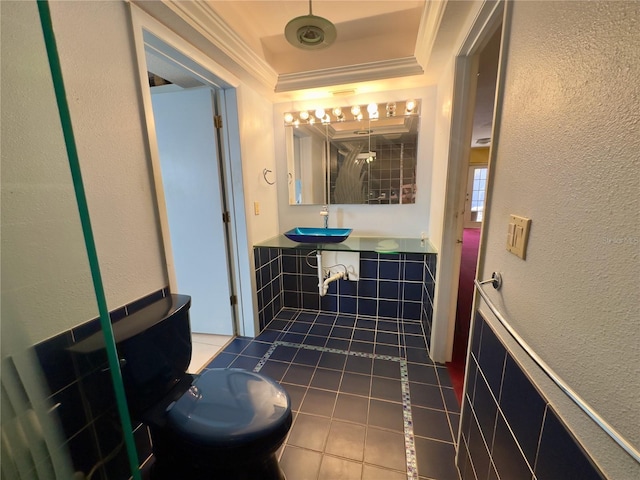 bathroom featuring ornamental molding, sink, and tile patterned floors