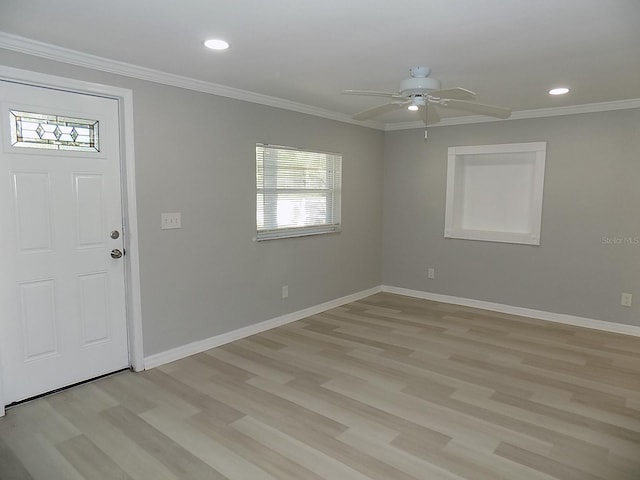 entryway with light hardwood / wood-style floors, ceiling fan, and ornamental molding