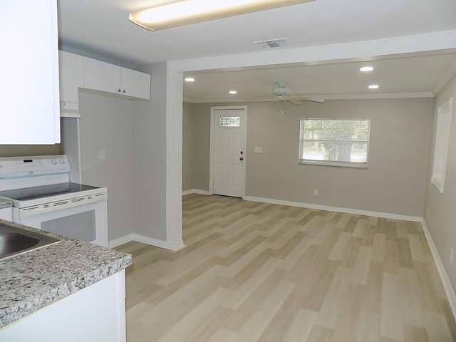 kitchen with electric range, light hardwood / wood-style flooring, white cabinets, and ceiling fan