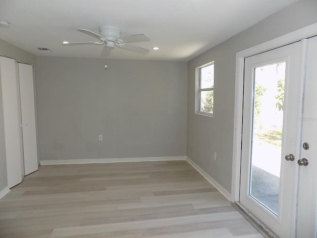 interior space with light wood-type flooring, access to outside, and ceiling fan