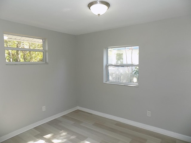 unfurnished room with light wood-type flooring