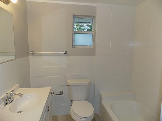 bathroom featuring vanity, a bathtub, toilet, and tile walls