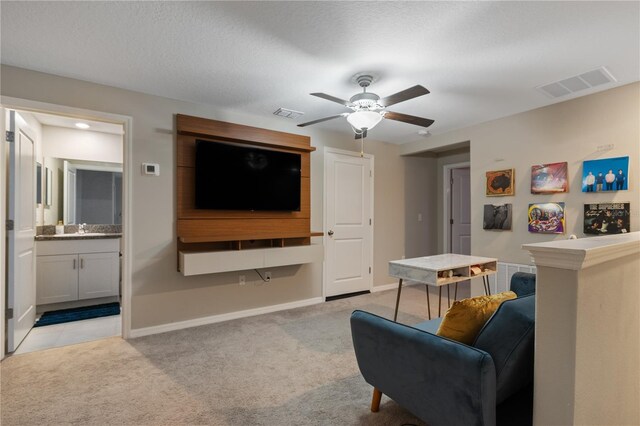 carpeted living room featuring a textured ceiling, ceiling fan, and sink