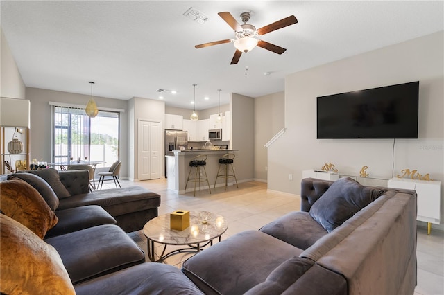 tiled living room featuring ceiling fan