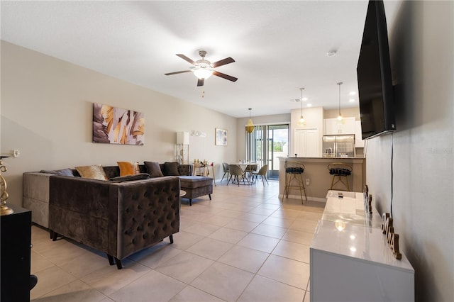 tiled living room with ceiling fan