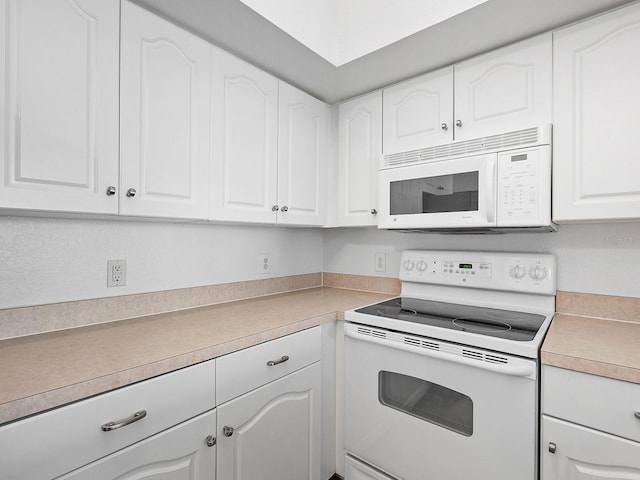 kitchen featuring white cabinetry and white appliances