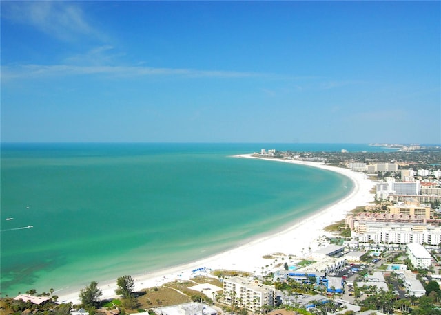 birds eye view of property with a water view and a beach view