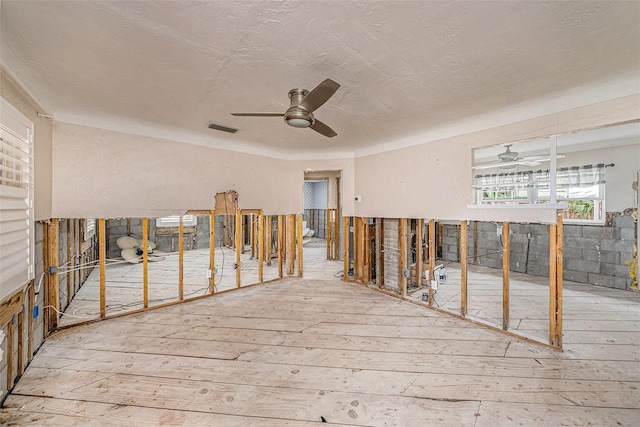 misc room with hardwood / wood-style flooring and ceiling fan