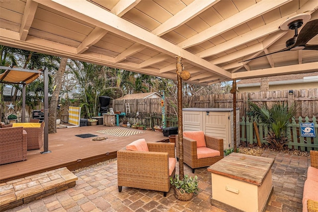 view of patio / terrace featuring an outdoor living space, ceiling fan, and a wooden deck