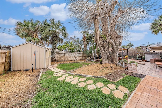 view of yard featuring a shed, a hot tub, and a patio