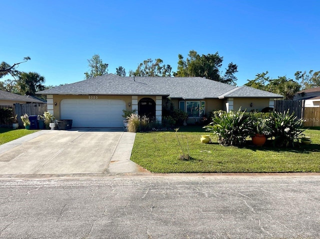 single story home featuring a garage and a front lawn