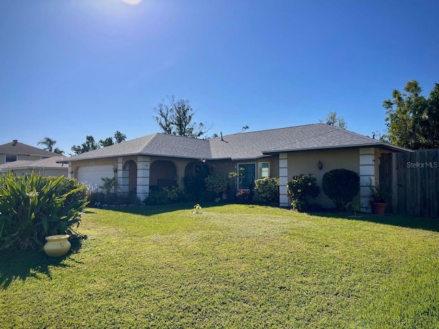 ranch-style house with a garage and a front lawn